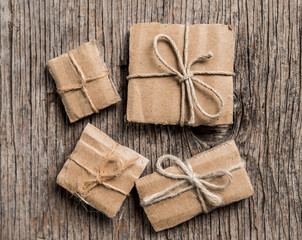 Fototapeta premium Handmade gift boxes on rustic wooden background