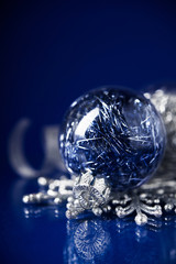 Silver and blue christmas ornaments on dark blue background. Merry christmas card. Winter holidays. Xmas theme.