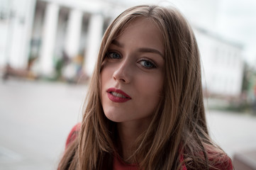 portrait of beautiful girl with blue eyes in red