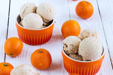 Homemade Ice cream with a citrus on a white wooden background
