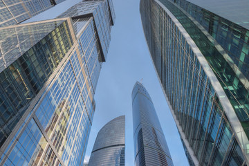 Fototapeta na wymiar Bottom view of modern skyscrapers in business district in morning
