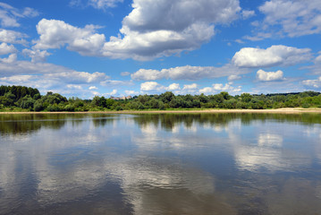 Landscape of beautiful Vistula river at summer day. Reflections of clouds in water. Poland, Europe.
