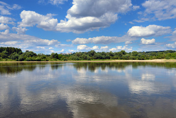 Landscape of beautiful Vistula river at summer day. Reflections of clouds in water. Poland, Europe. 
