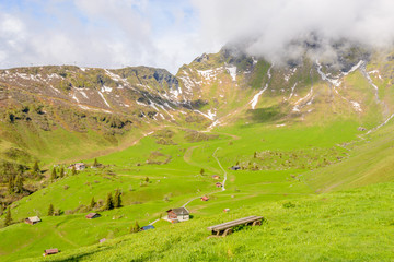 Fototapeta na wymiar Beautiful Swiss mountain valley landscape with a single house.