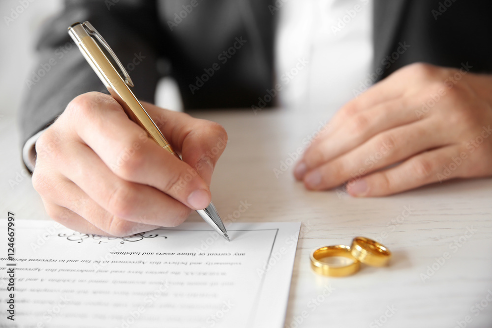 Wall mural man signing marriage contract, closeup