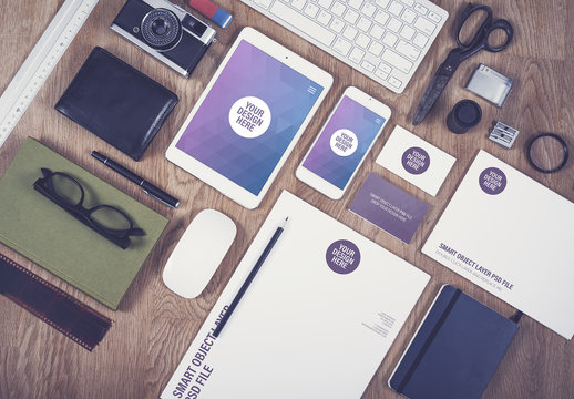 Smartphone, Tablet, and Stationery on a Wooden Desk Mockup 1