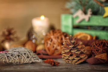 Composition of cone, anise and wicker decor on wooden background, close up view