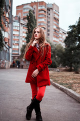 Fototapeta premium portrait of beautiful girl with blue eyes in red