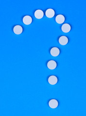 Question mark with pills