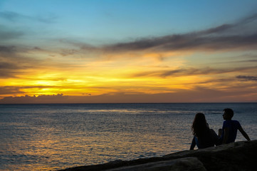Naklejka na ściany i meble Couple watching the Sunset