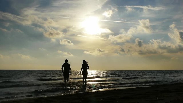 Happy couple running joyfully on sea shore