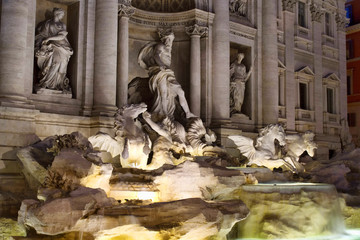 Fontana Di Trevi (Trevi Fountain) at night in Rome. Aqueduct-fed rococo style, designed by Nicola Salvi & completed in 1762, with sculpted figures.