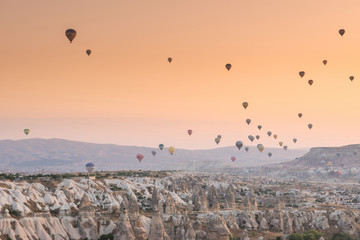 Hot air balloon flying over rock landscape at Cappadocia Turkey