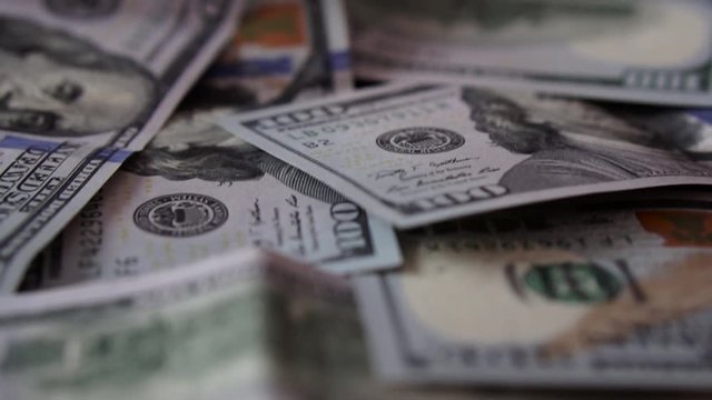 Scattered Banknote 100 Dollars on table