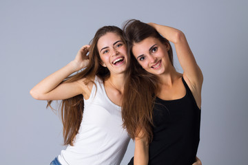 Fototapeta na wymiar Two young women embracing