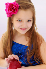 Little girl holds in hands Red apples