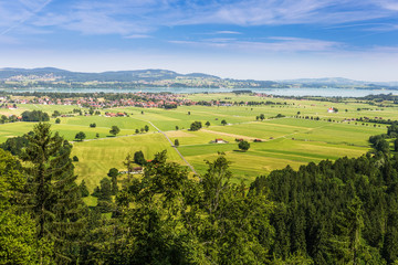 Obraz premium Schwangau. Forggensee. Green fields next to Neuschwanstein castl