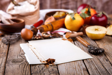 Baking Background. Ingredients  for baking Apple Pie  - apples,spices ,flour,  rolling pin, eggs, egg yolks, butter served.Vintage style.selective focus. Copy space.