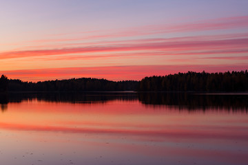 Fototapeta na wymiar Serene view of calm lake and sunset clouds