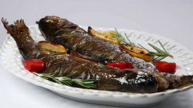 delicious trout fish baked with lemon, tomatoes and spices