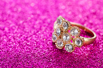 Jewellery concept with ring on shiny background