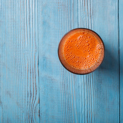Fresh Carrot juice in a glass on wooden background.Healthy food or diet concept.Copy space. selective focus.