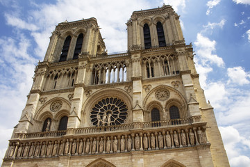 Fototapeta na wymiar Close up view of Notre Dame Cathedral in Paris. Towering, 13th-century cathedral with flying buttresses & gargoyles, setting for Hugo's novel.