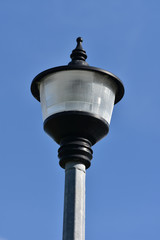 Fototapeta na wymiar Circular street lamp on octagonal metal pole.
