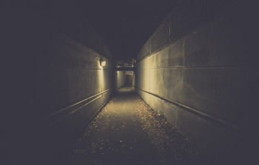 Empty underpass tunnel at night, desaturated colors