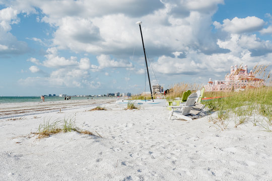 White sand, sea oats and a sailboat on Pass-A-Grille's beach