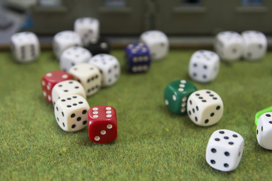 many colored dice on a green table cloth
