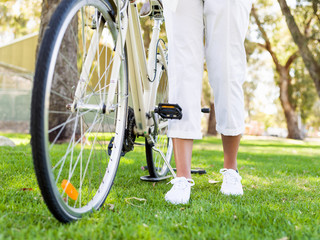 Naklejka premium Happy young woman with bicycle