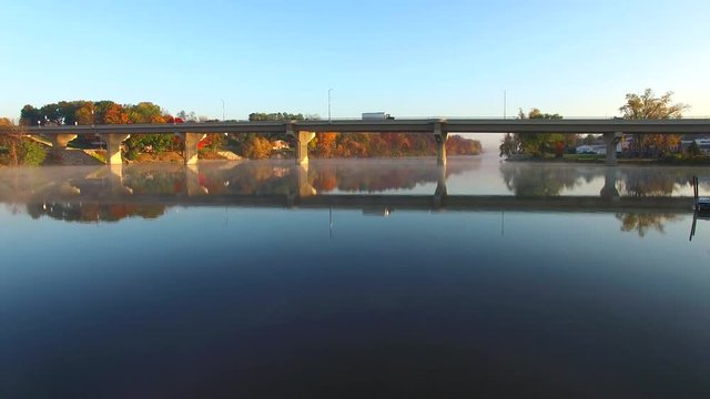 Scenic drone flight under bridge with Autumn colors.
