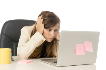 businesswoman suffering stress at office computer desk looking worried depressed and overwhelmed