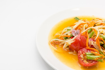 Spicy green papaya salad or somtum isolated on white background with copy space for text, Thai cuisine