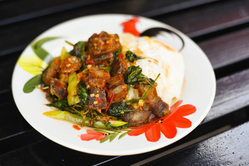 Rice and stir-fried crispy pork and basil topped with Fried egg