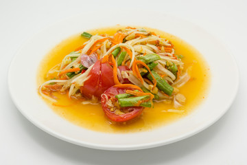 Spicy green papaya salad or somtum isolated on white background with copy space for text, Thai cuisine