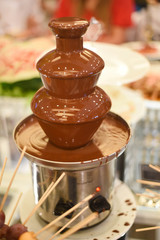 Chocolate fountain placed on a table in wedding day