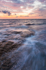 Fototapeta na wymiar Long exposure sea and rocks at twilight