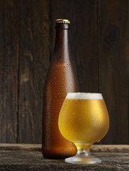 beer glass and bottle on a wooden background