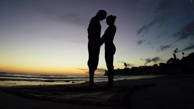 Acroyoga lifestyle beach sunset, silhouette beauty shot.