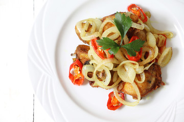 Asian cuisine fried chicken with turmeric, onion and chili