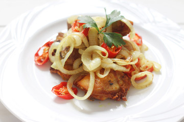 Asian cuisine fried chicken with turmeric, onion and chili