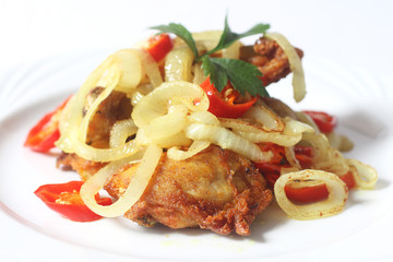 Asian cuisine fried chicken with turmeric, onion and chili