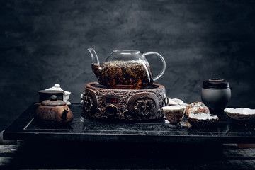 Traditional herbal tea in transparent glass teapot.