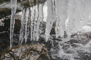 frozen icicles on the rock near the waterfall