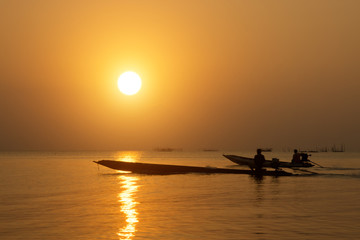 silhouette of fishermen in a boat.
