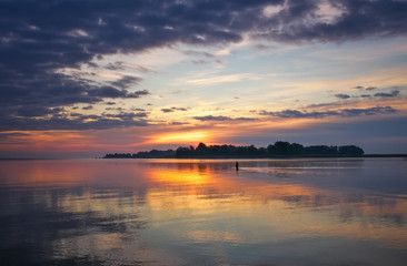 Fototapeta premium Beautiful landscape with sunset fiery sky and sea. 
