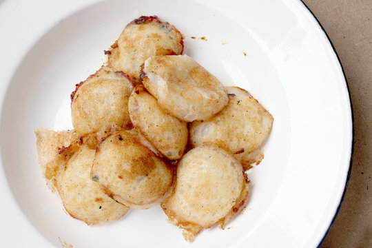 Kind of Thai sweetmeat , thai dessert, Thai coconut pudding. Kanom Krok stuffed with corn on cutting board with wooden table.
