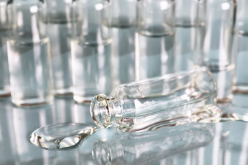 transparent vials of medicine